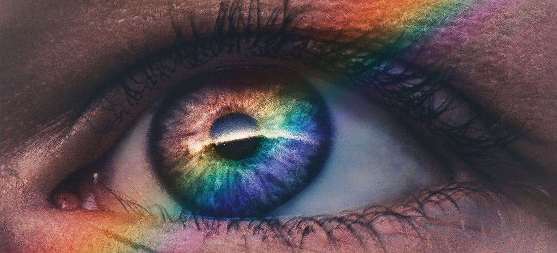 Close up eye and rainbow reflection